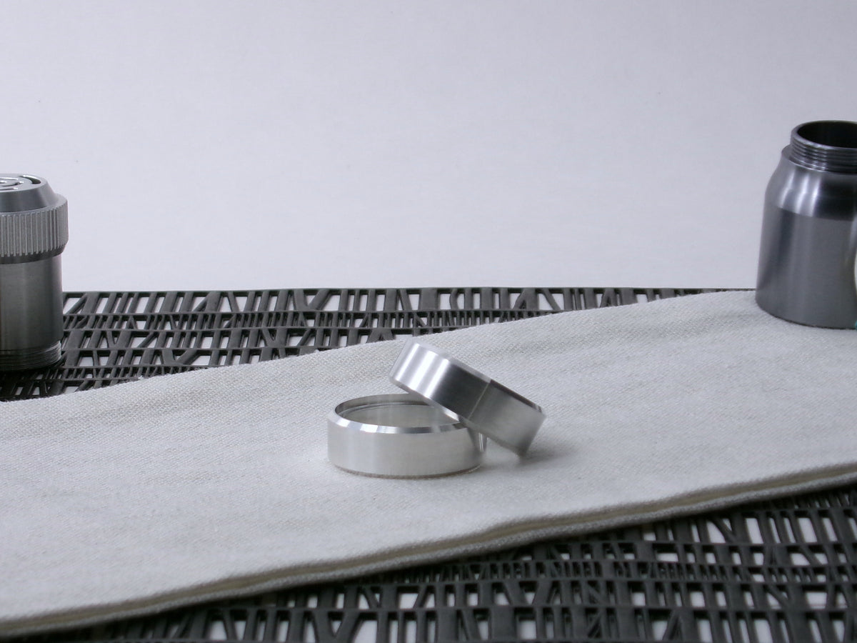 A pair of VHC-compatible lightsaber, Accent Bands sit askew on a cloth.