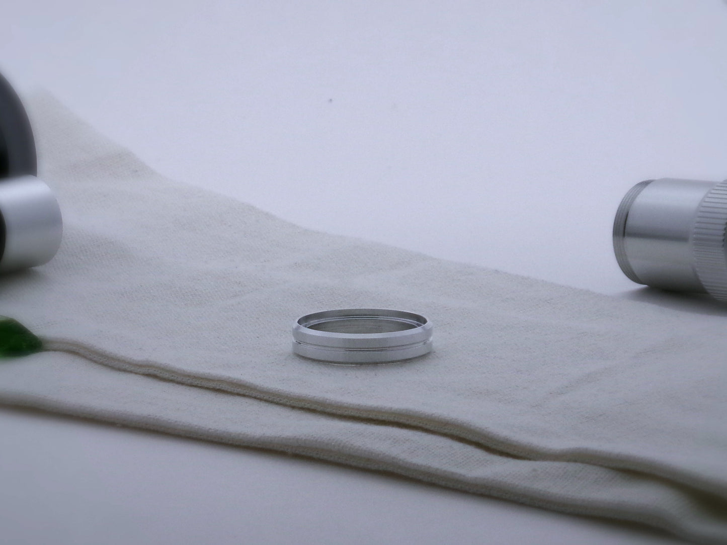 Single, aluminum accent ring for VHC lightsabers, with beveled edges and a central groove; shimsert facing upward.