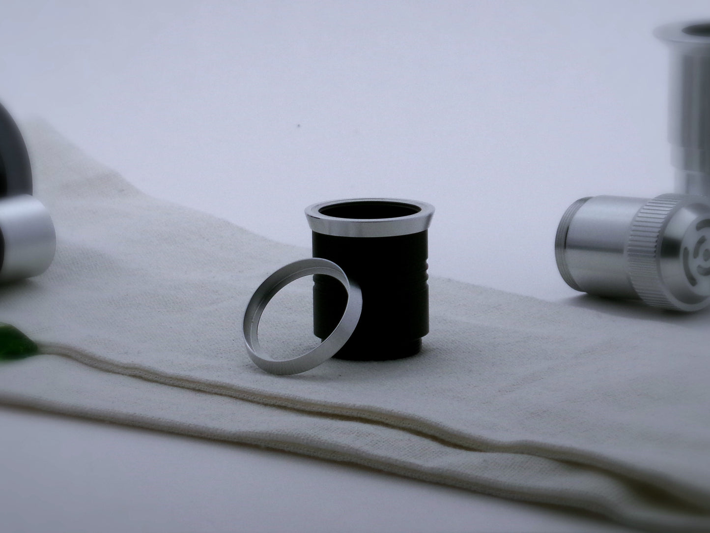 A pair of beveled accent rings for VHC lightsabers, the first installed on a black grip extension, the second leaning against it.