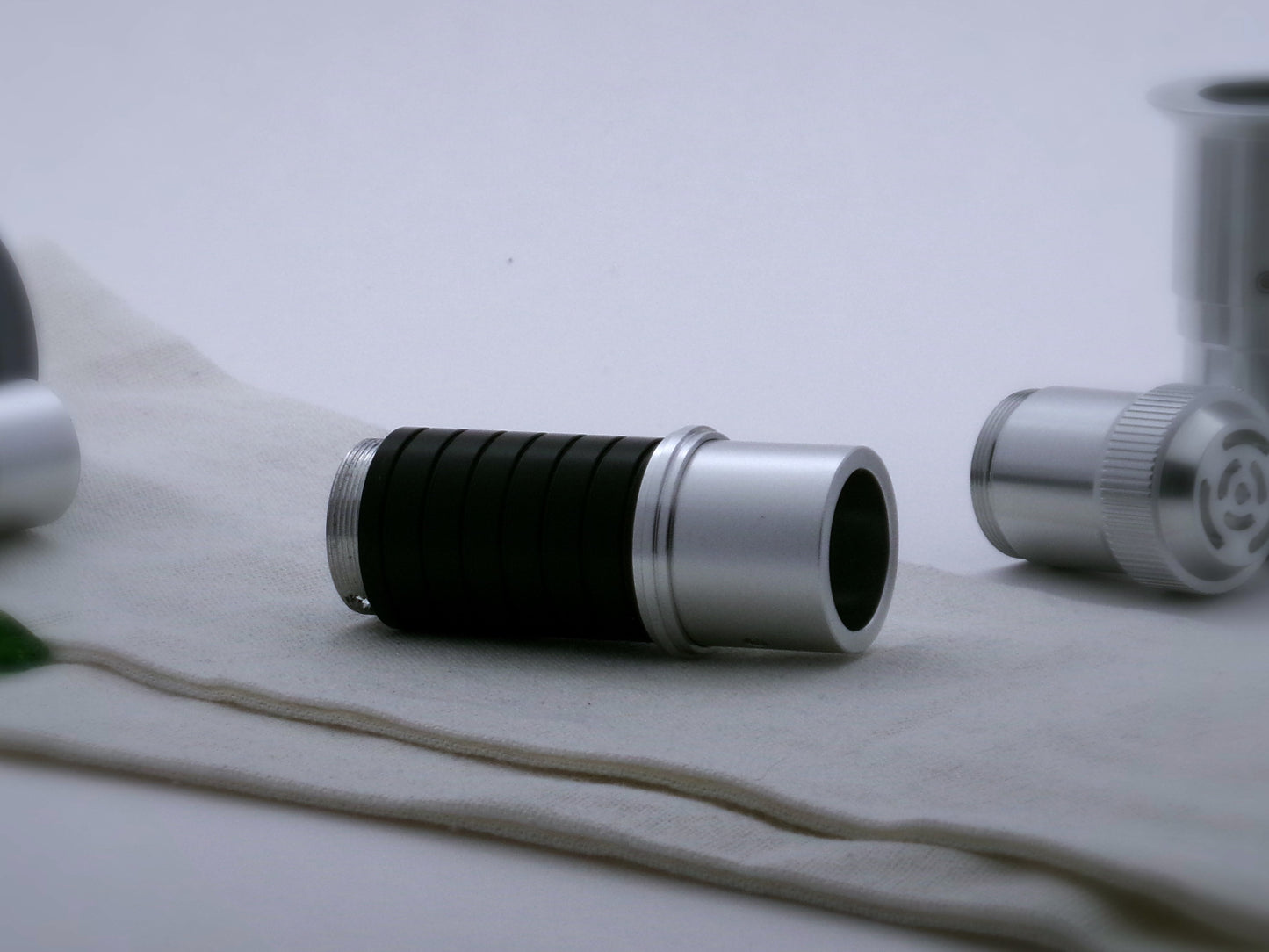 Single, aluminum accent ring with a proud central rib installed on a mixed VHC lightsaber component part.