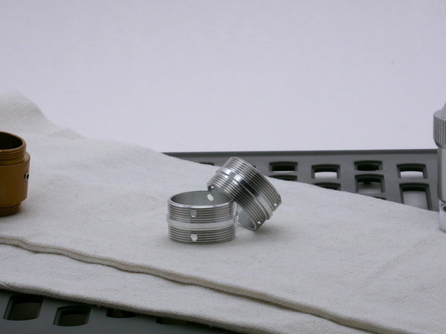 Pair of aluminum male/male threaded adapter for VHC lightsabers set askew; 30mm diameter.
