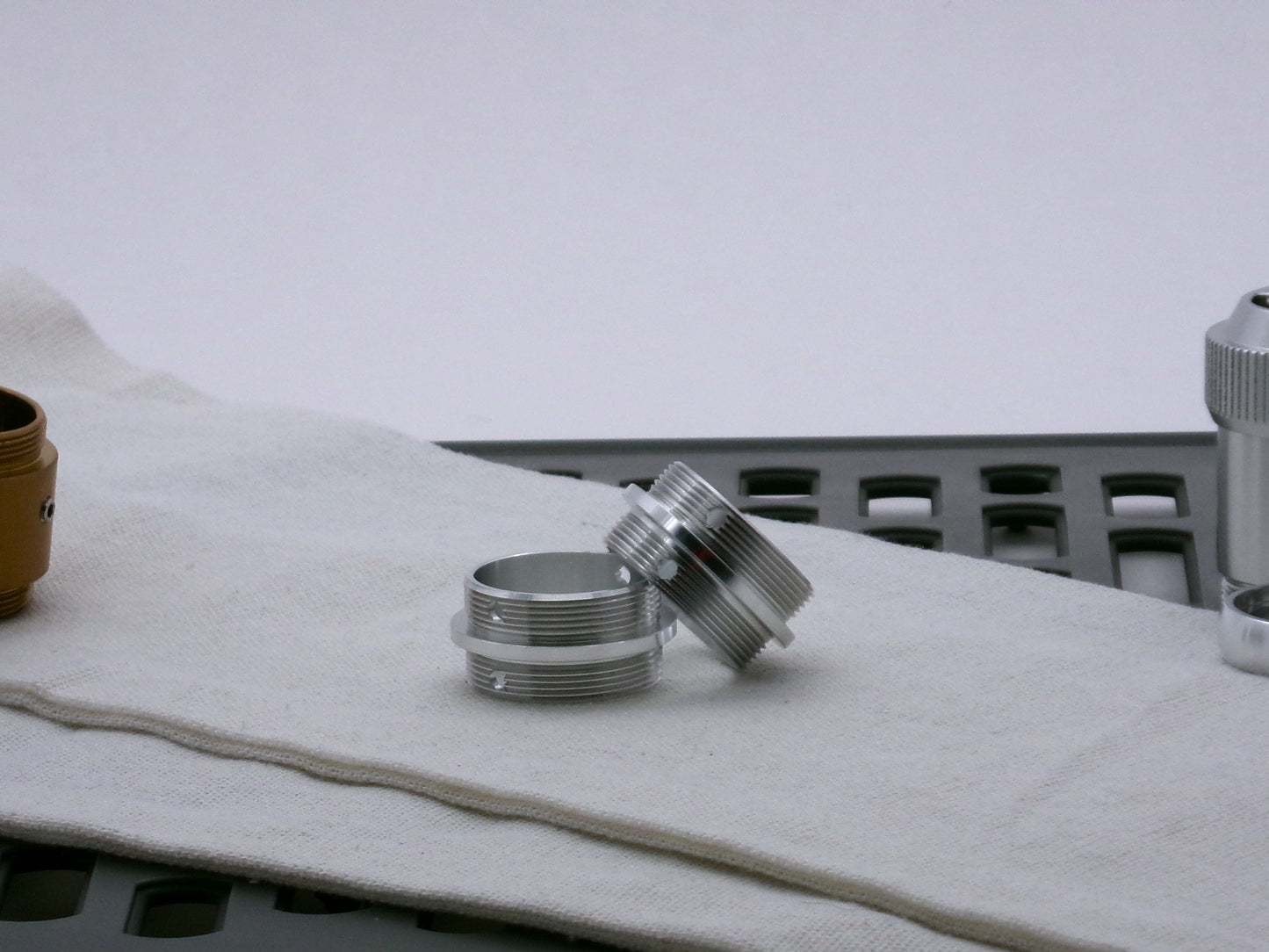 Pair of aluminum male/male threaded adapter for VHC lightsabers set askew; 33mm diameter.