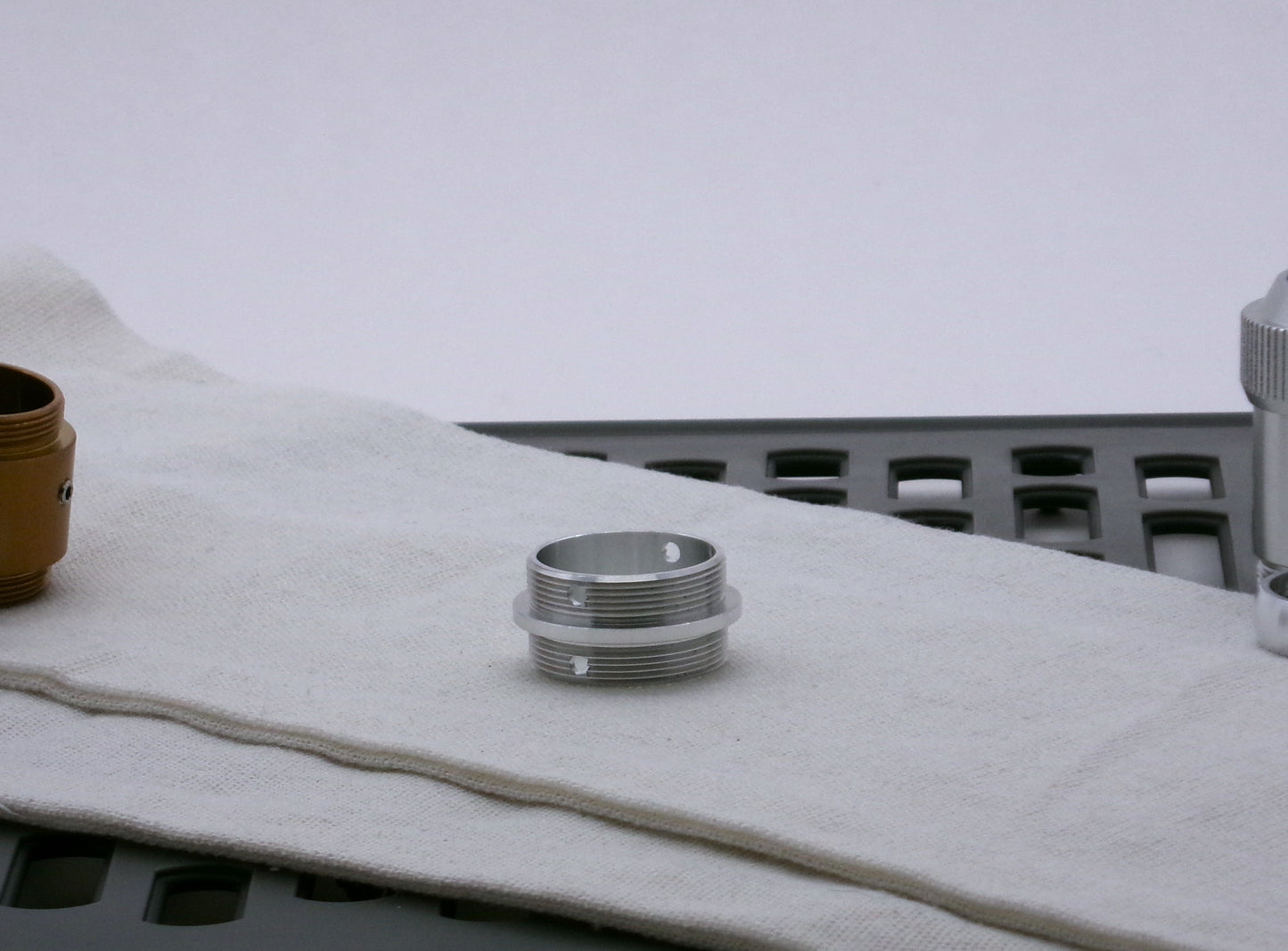 Single aluminum male/male threaded adapter for VHC lightsabers set askew; 33mm diameter.