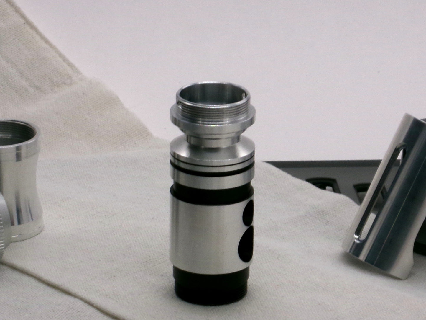 A versatile, aluminum male-to-male hybrid adapter compatible with VHC lightsabers, installed on a VHC switch, standing proud.