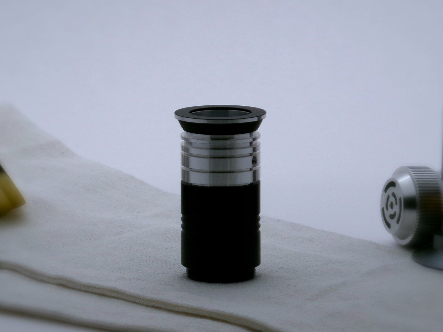 An aluminum, Male/Male threaded, adapter adorned with ribs and grooves in the Clan Lightsaber style incorporated into a VHC lightsaber emitter.