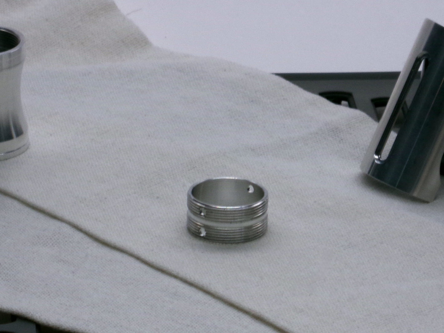 A stealthy, no-show, aluminum male-to-male formatted adapter that hides between female formatted parts lying flat.