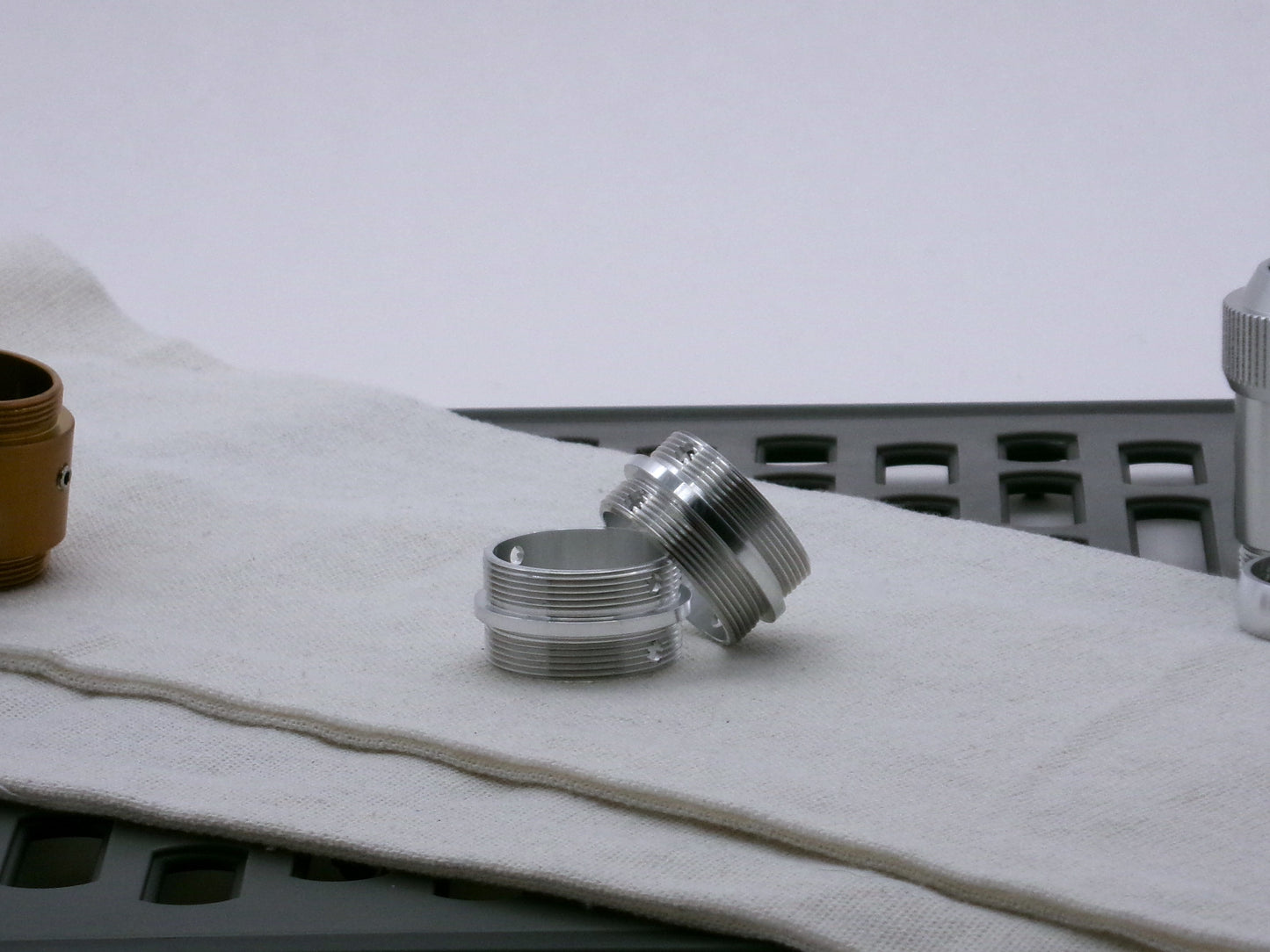 Pair of aluminum male/male threaded adapter for VHC lightsabers set askew; 31.5mm diameter.