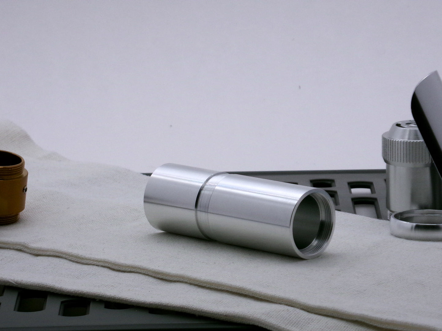Single aluminum female/female threaded VHC lightsaber body component installed below a Adapter_MM-Type_2; three-quarter view.