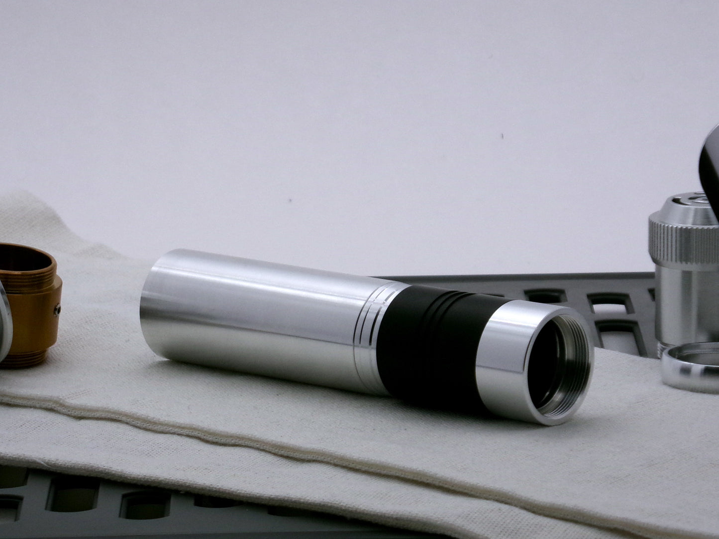Single aluminum female/female threaded body component installed on mixed VHC lightsaber components; three-quarter view.