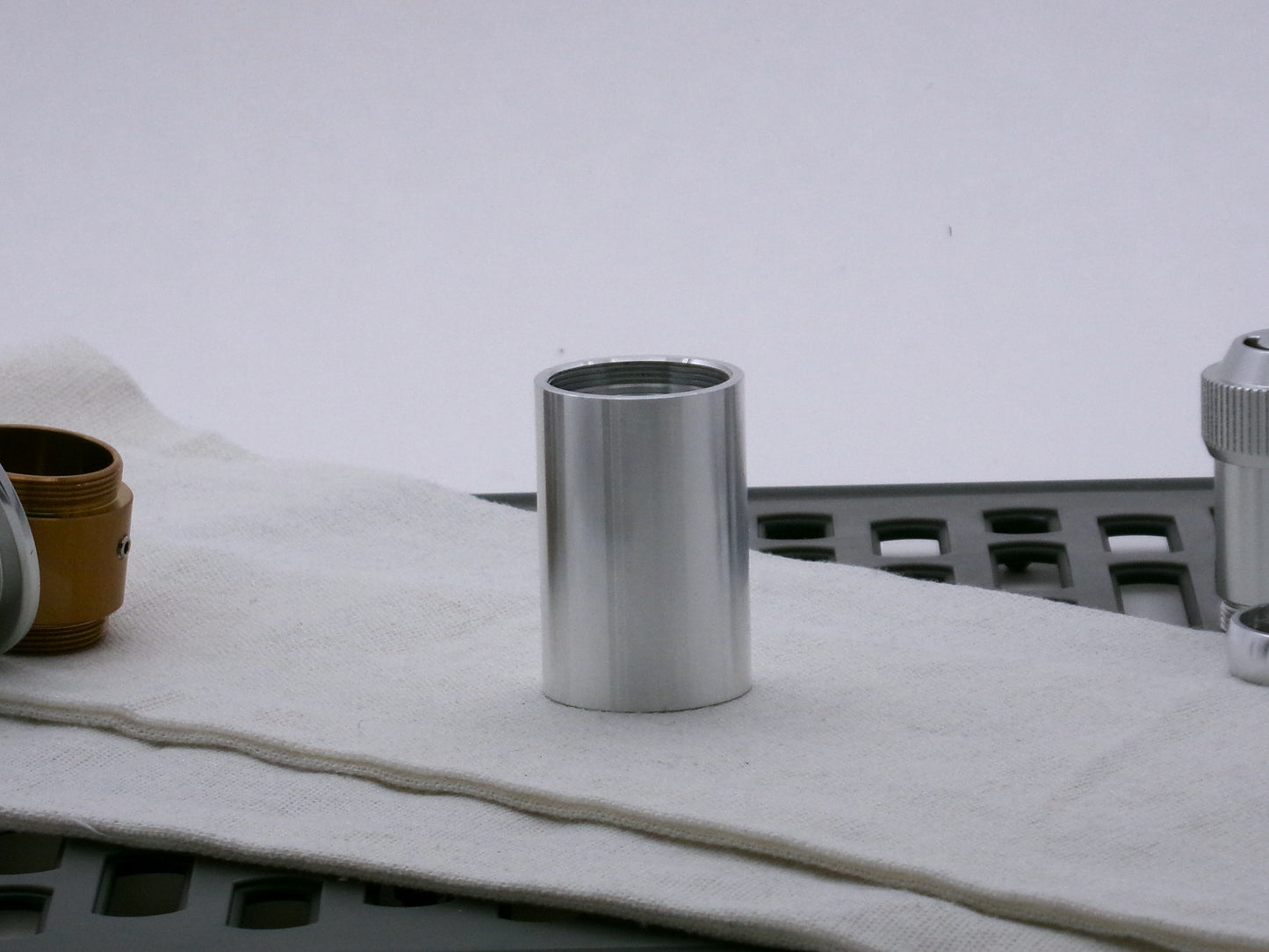 Single aluminum female/female threaded body component for VHC lightsabers; standing proud.
