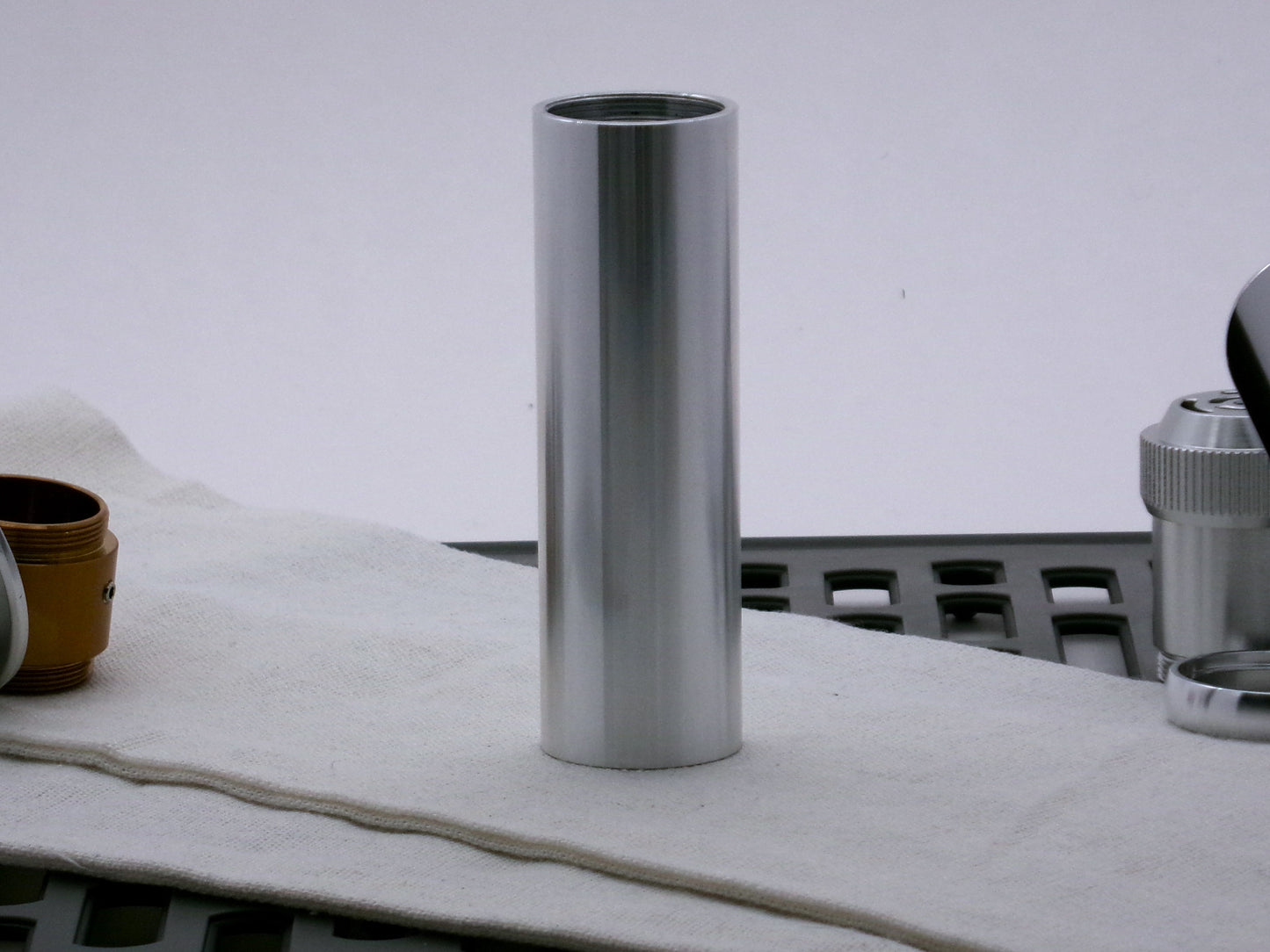 Single aluminum female/female threaded body component for VHC lightsabers; standing proud.