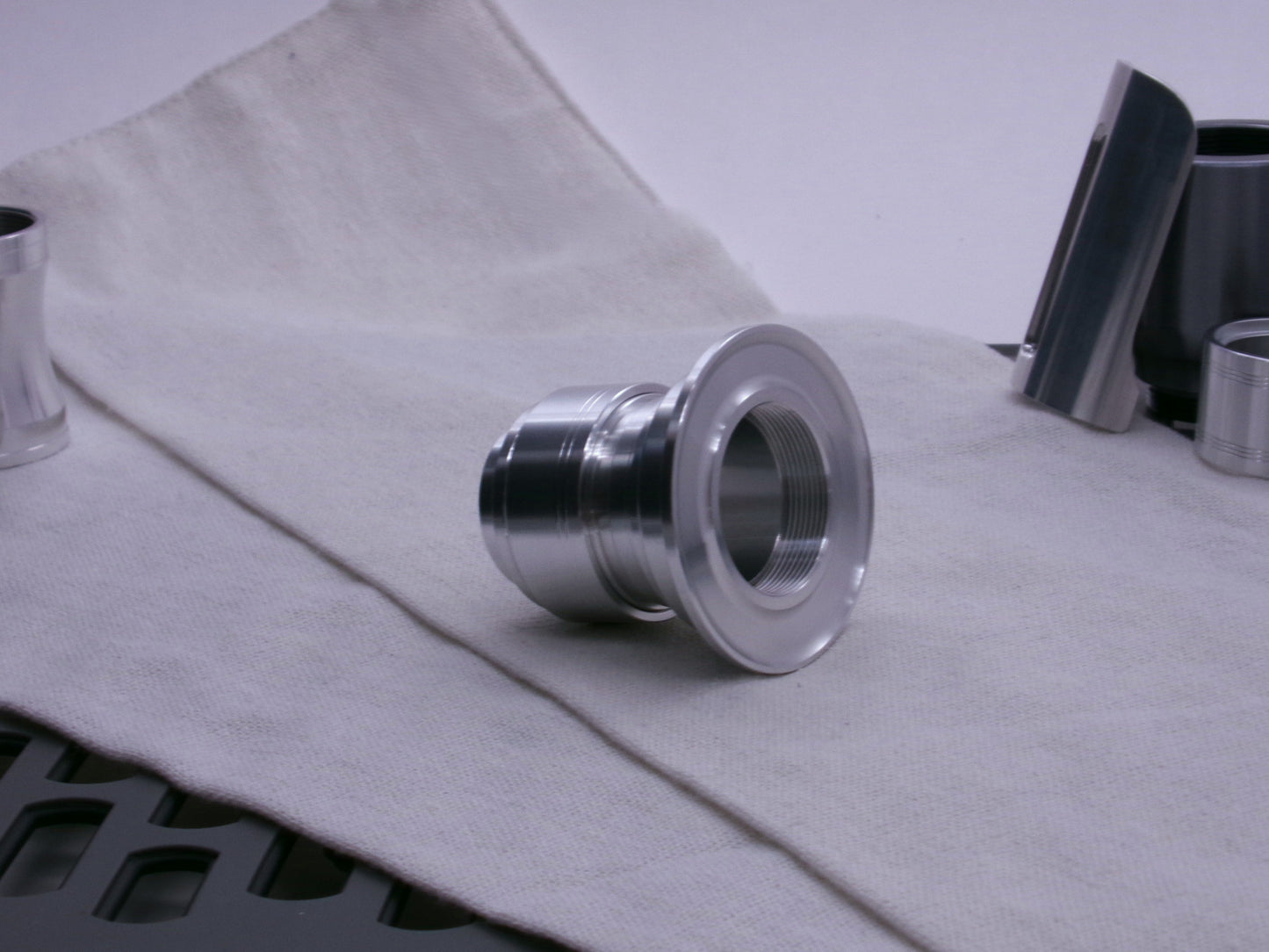 An aluminum emitter flange tops a composition of VHC compatible lightsaber components from Corvus Saber Foundry.