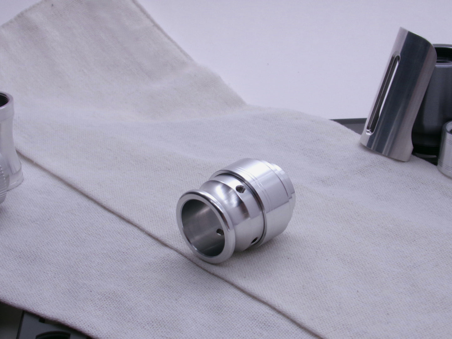 An aluminum VHC compatible emitter tip, completes a mockup shown 3/4 view on a coarse cloth.