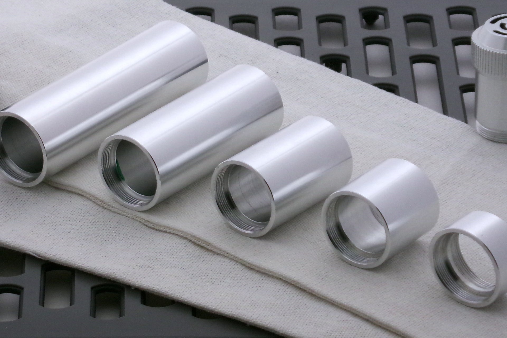 Array of aluminum body components for VHC lightsabers.