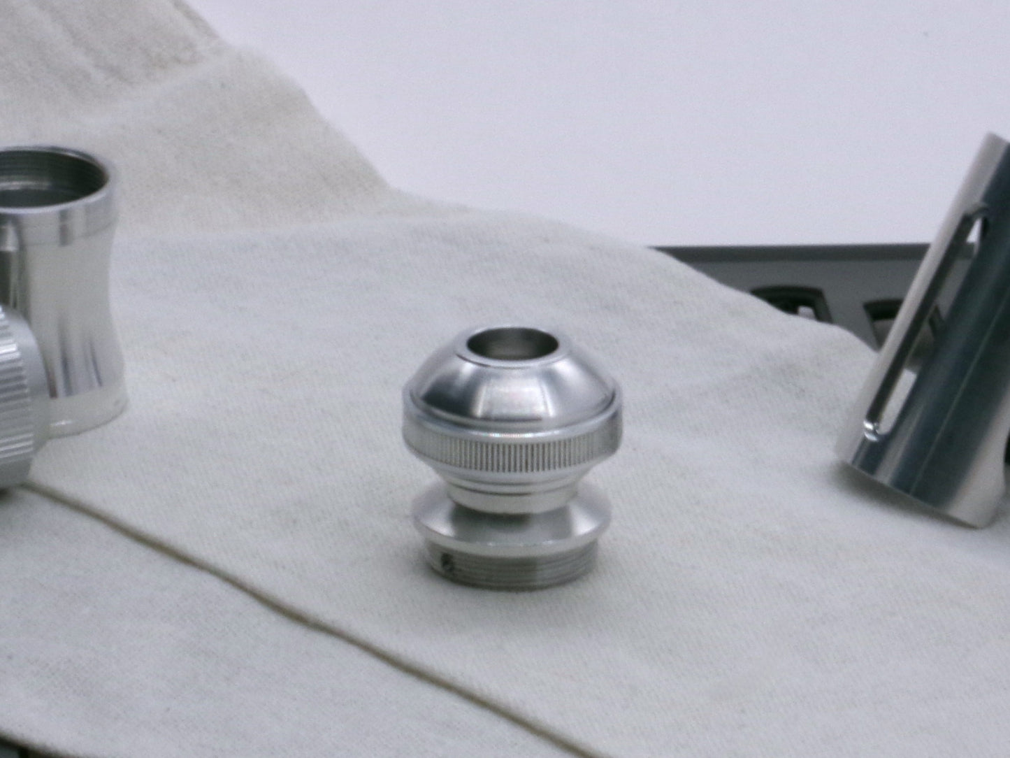 A basic, aluminum female-threaded pommel installed on Adapter MM Hybrid Type 1 with Accent Ring Type 1.1 showing versatility, standing vertical.