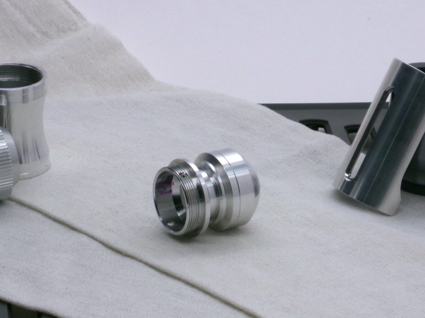 A basic, aluminum female-threaded pommel installed on Adapter MM Hybrid Type 1 in 3/4 view.