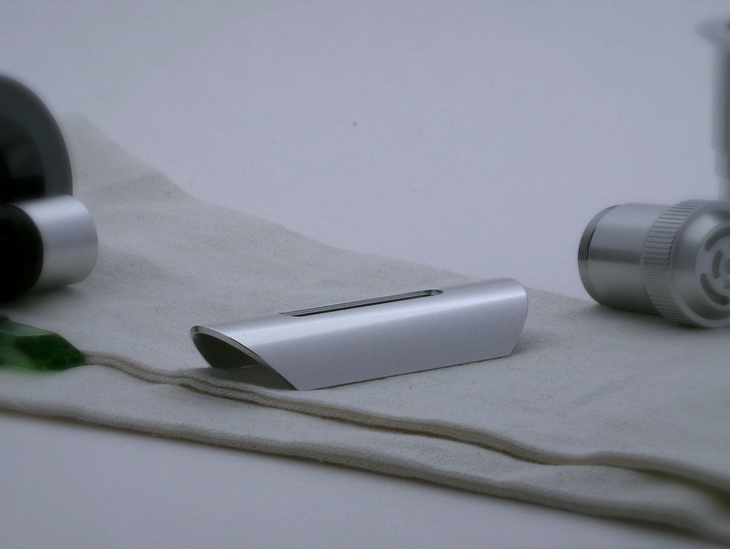 Aluminum half shroud for VHC lightsabers with angled ends and a universal slot; three quarter view.