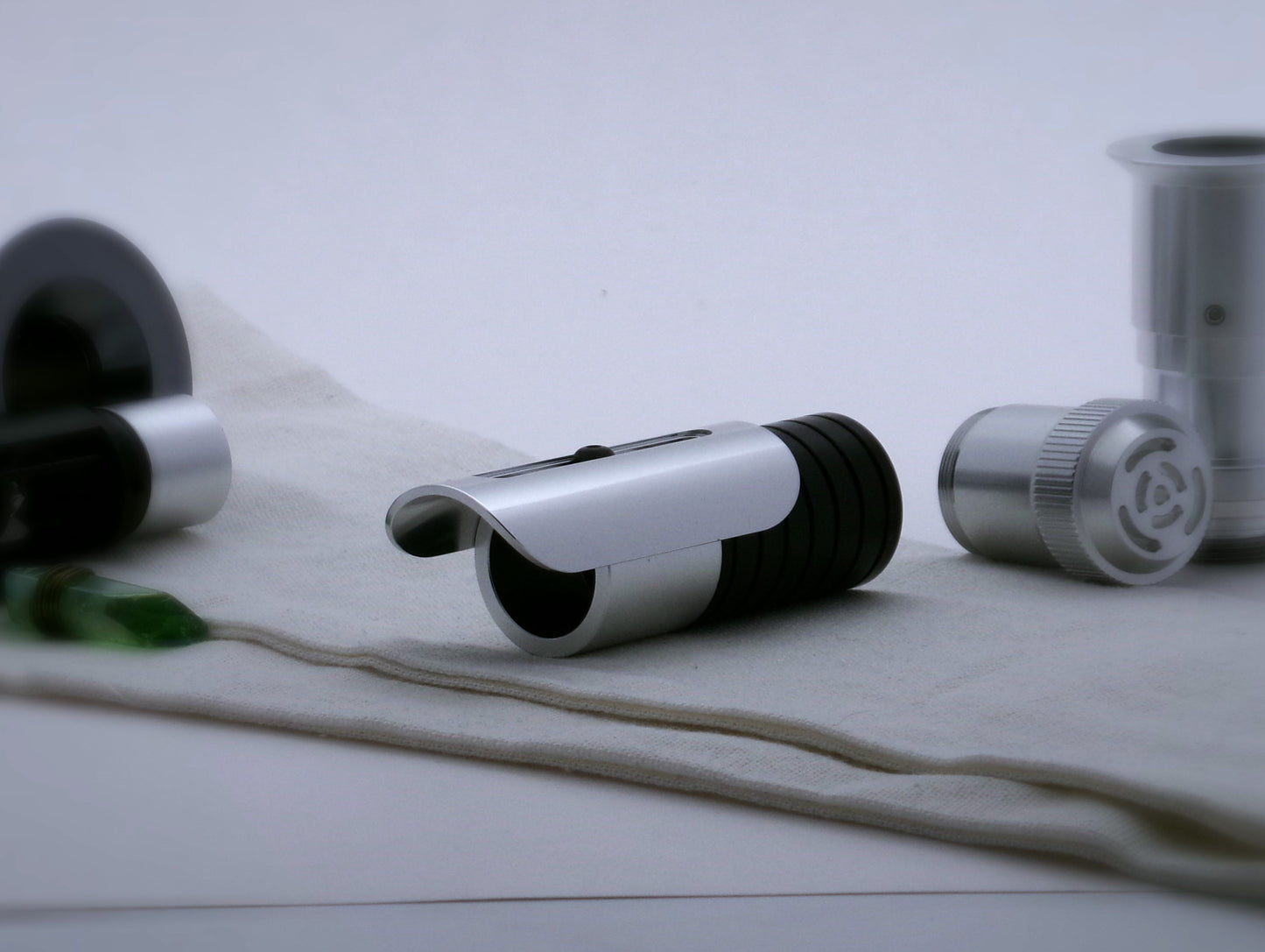 Aluminum, half shroud with rounded corners for VHC lightsabers mounted by universal slot to an emitter mock-up; three-quarter view.