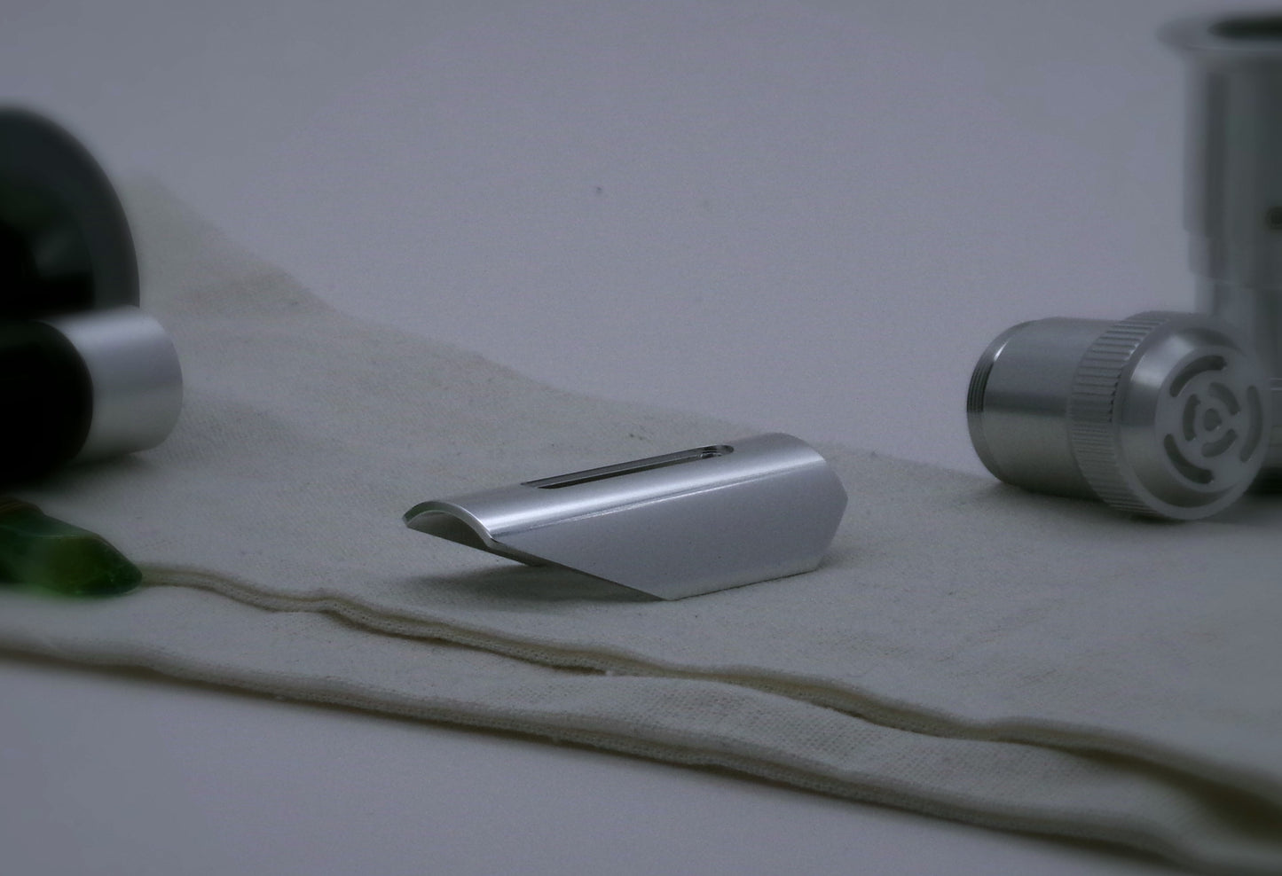 Small shield shaped, aluminum half shroud for VHC lightsabers with angled ends; three quarter view.