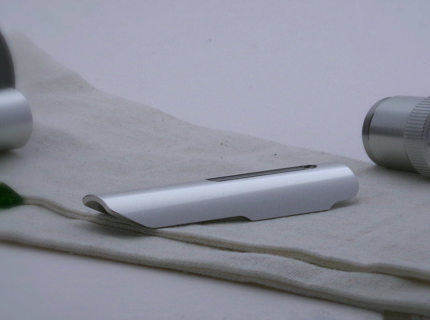 Single, aluminum half shroud for VHC lightsabers of Kestis design; three quarter view.