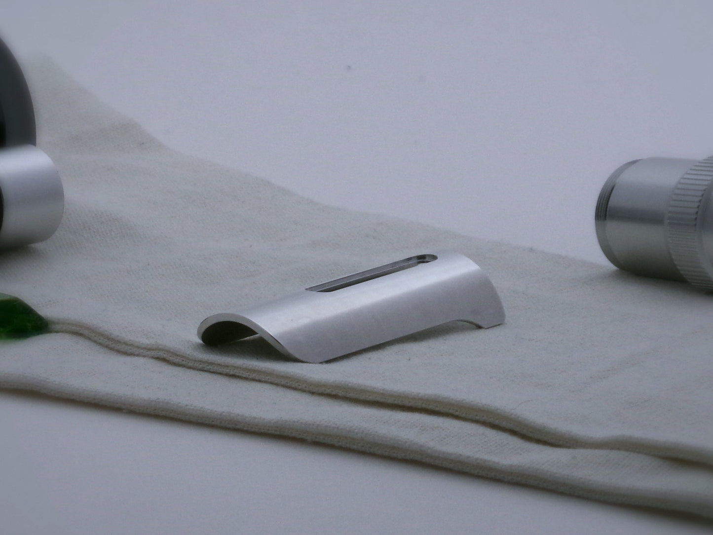 Single, short aluminum half shroud for VHC lightsabers of Sabine Wren design; three quarter view.