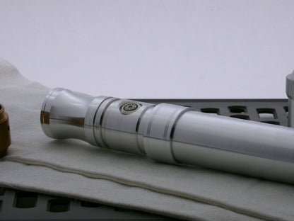 Single aluminum accent band sporting two-trios of debossed embellishments installed on a VHC lightsaber hilt.