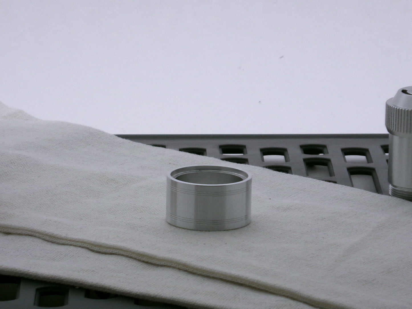 Single aluminum accent cap for VHC lightsabers, shimsert facing upward, with pair a triple debossed grooves.