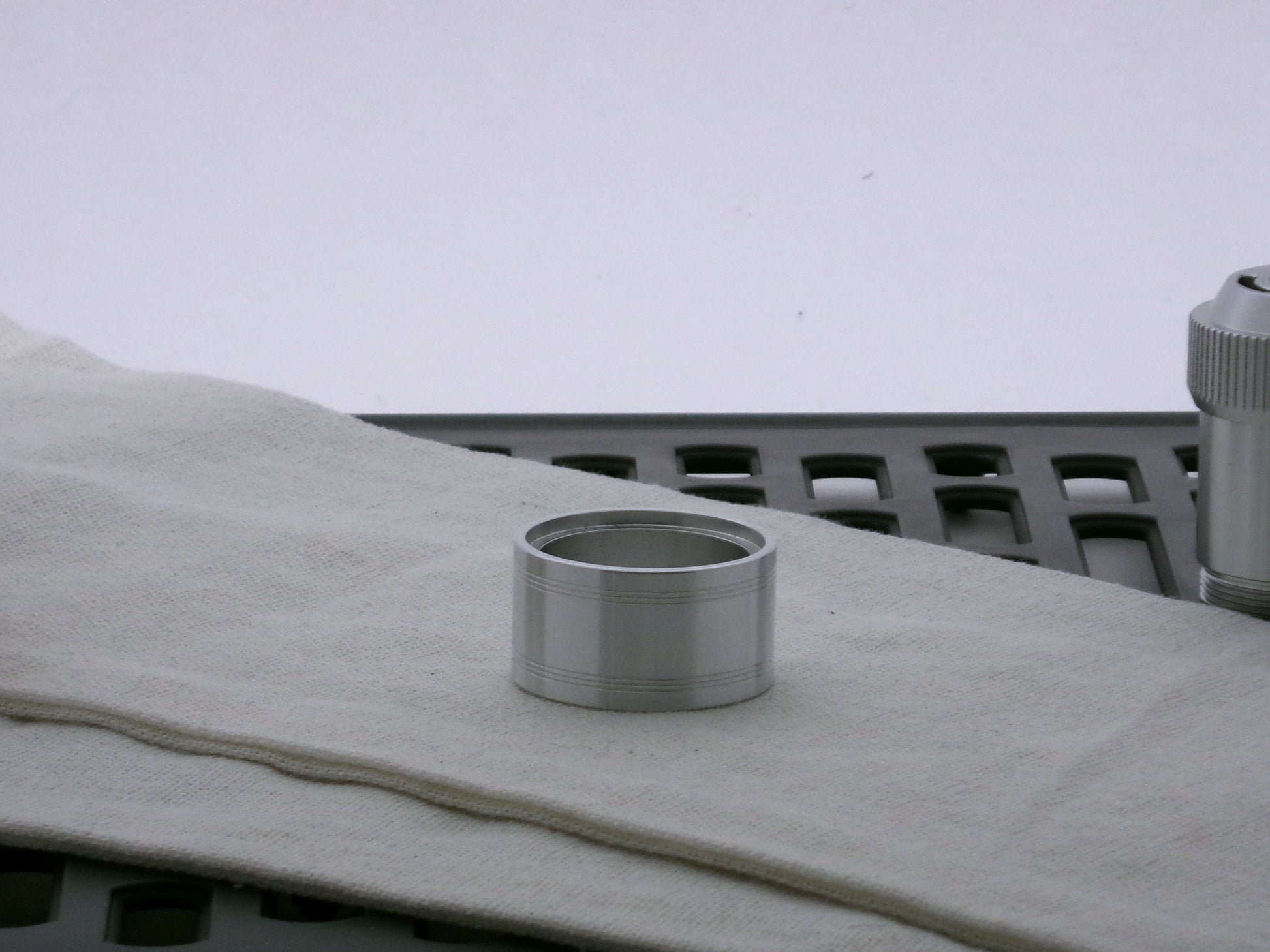 Single aluminum accent cap for VHC lightsabers, shimsert facing upward, with pair a triple debossed grooves.