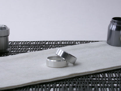 A pair of VHC-compatible lightsaber, Accent Bands sit askew on a cloth.