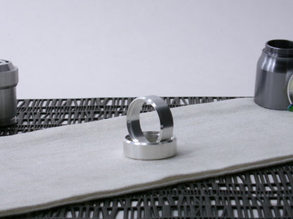 A pair of VHC compatible lightsaber accent bands, one supporting the other on cloth.