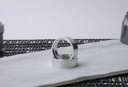 Pair of VHC-compatible Accent Band Type_3's, one standing in the other on a canvas cloth.