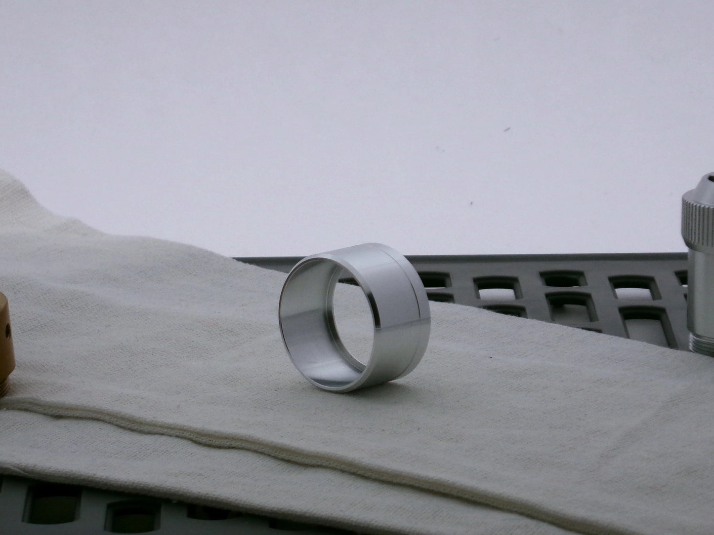 Single aluminum lightsaber accent cap for VHC lightsabers, three-quarter view showing inner detail and shimsert.