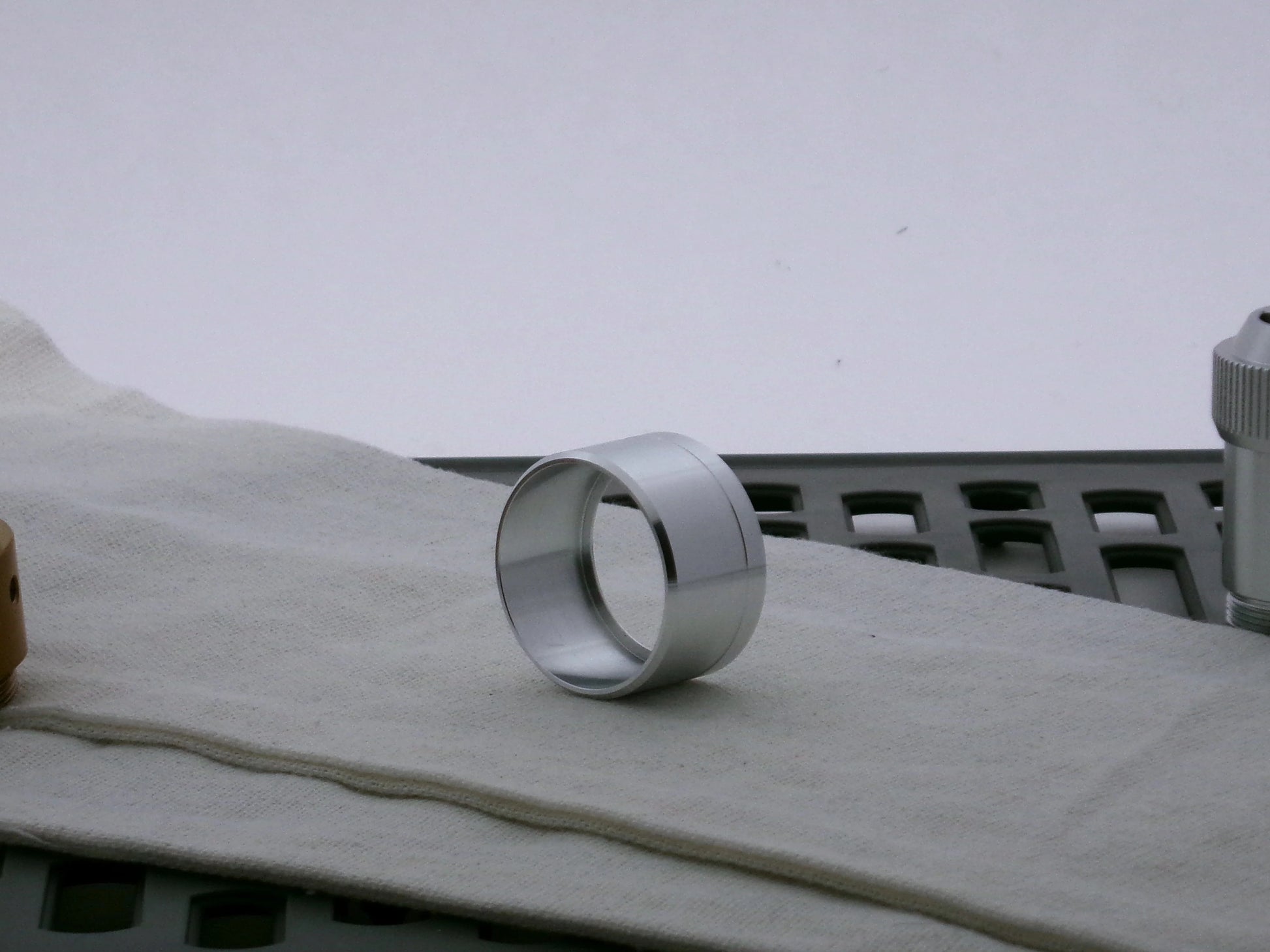 Single aluminum lightsaber accent cap for VHC lightsabers, three-quarter view showing inner detail and shimsert.