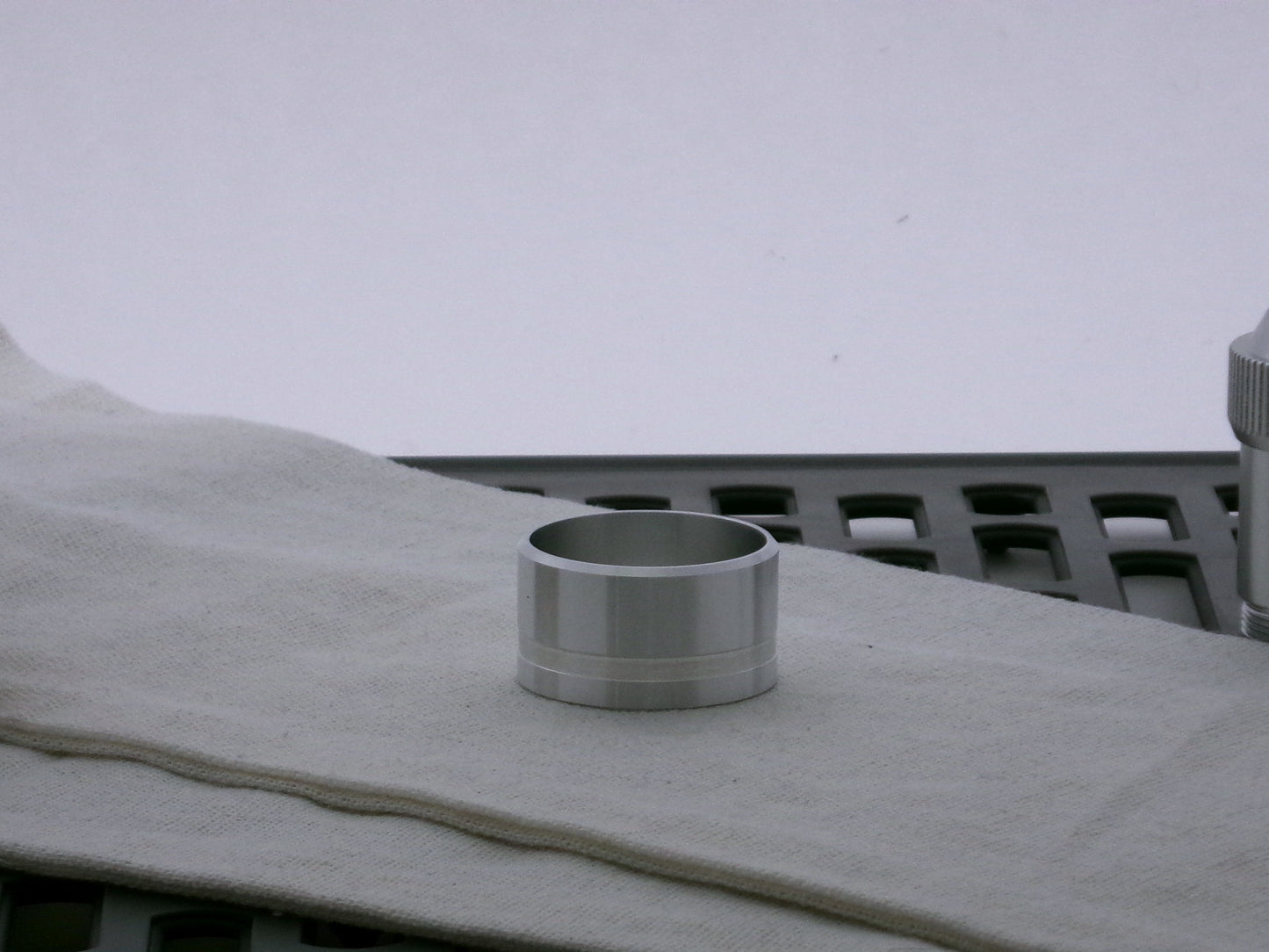 Single aluminum accent cap for VHC lightsabers, beveled edge facing upward, with one debossed groove. 