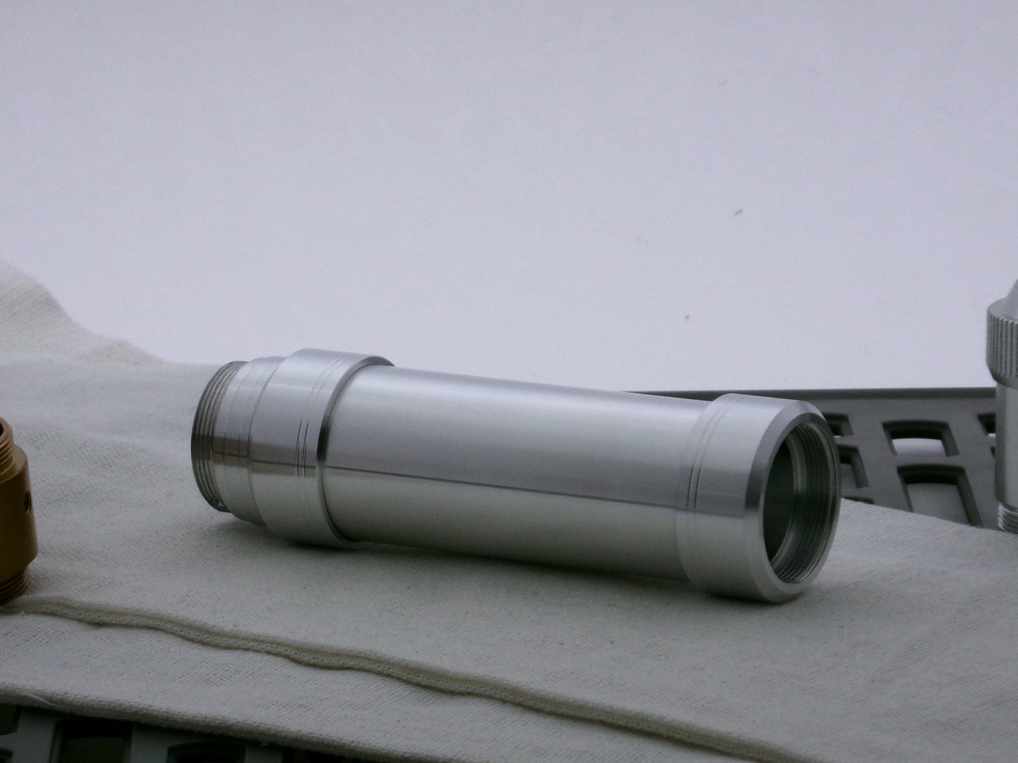 Two aluminum accent caps for VHC lightsabers on both ends of a VHC grip, with the distant end retained by a M/M Adapter