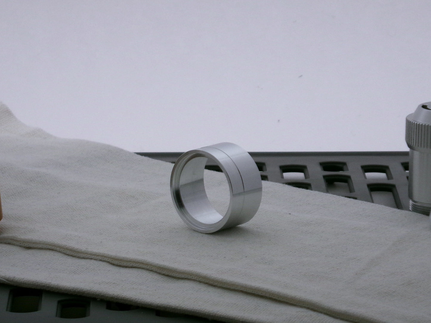 Single aluminum accent cap designed for use on VHC lightsabers, three-quarter view showing detail of shimsert recess.