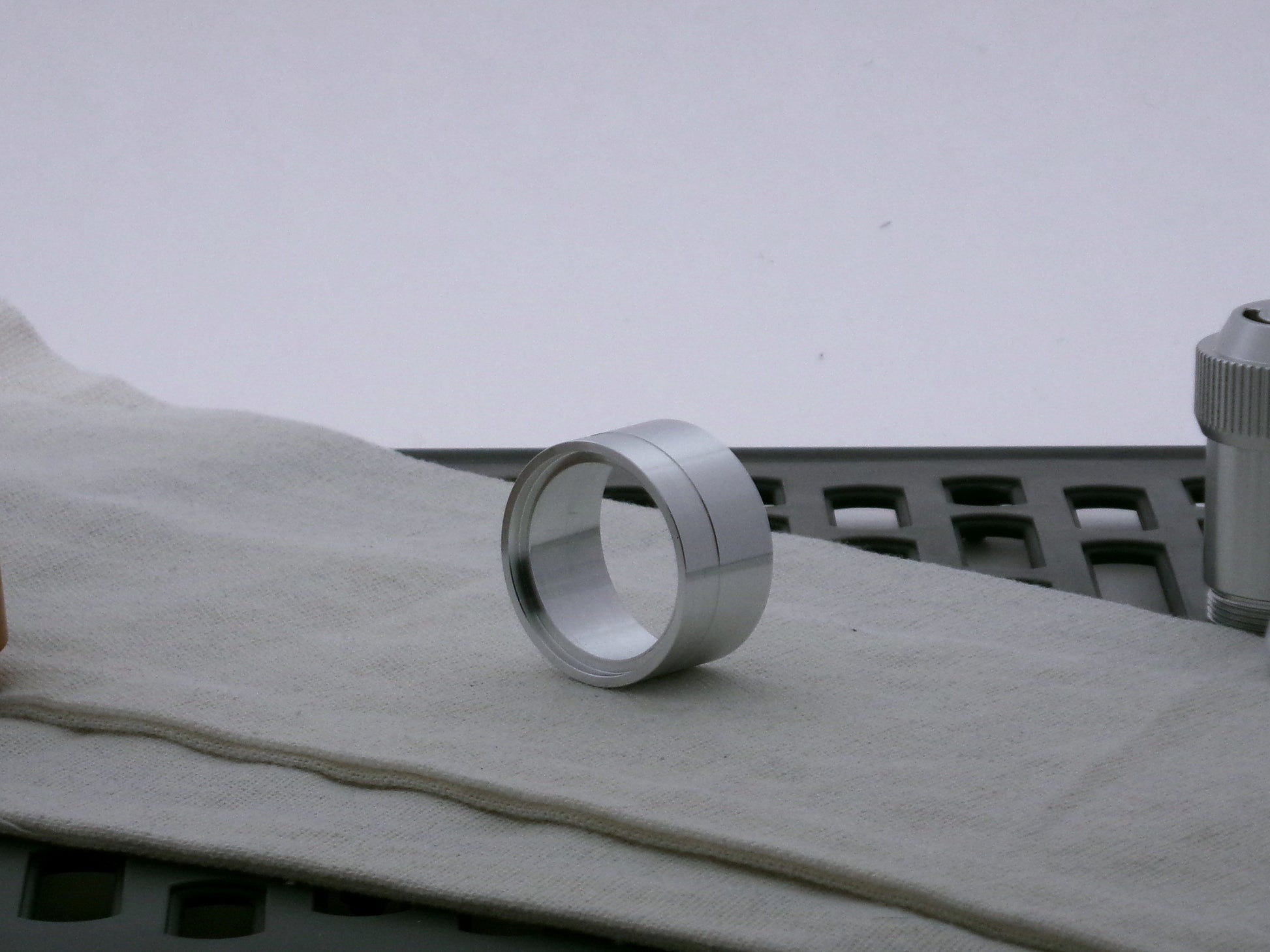 Single aluminum accent cap designed for use on VHC lightsabers, three-quarter view showing detail of shimsert recess.