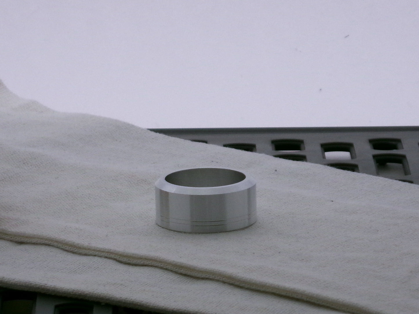 Single aluminum accent cap for VHC lightsabers, beveled edge facing upward, with two embossed grooves. 