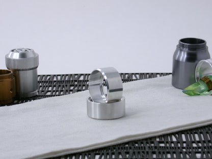Pair of VHC-compatible, lightsaber Accent Caps, one standing in the other on a canvas cloth.