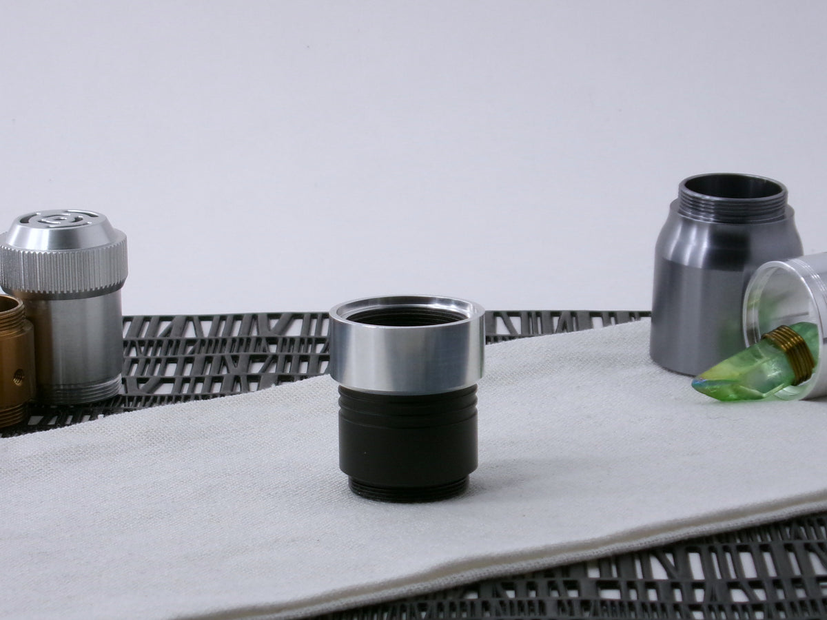 A VHC-compatible, lightsaber Accent Cap, positioned for installation, shim side up on a VHC-component.
