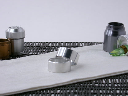 Pair of VHC-compatible, lightsaber Accent Caps, askew on a canvas cloth.