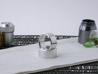 Pair of VHC-compatible, lightsaber Accent Caps, one standing in the other on a canvas cloth.