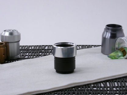 A VHC-compatible, lightsaber Accent Cap, positioned for installation, shim side up on a VHC-component.
