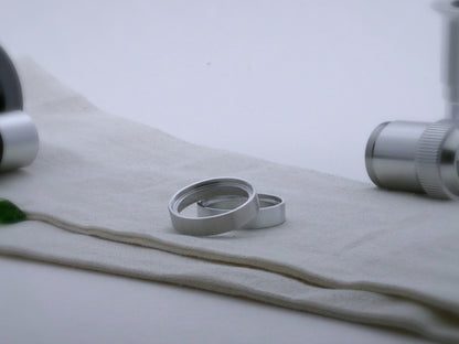 Pair of simple aluminum accent rings for VHC lightsabers, one askew upon the other, showing shimsert.