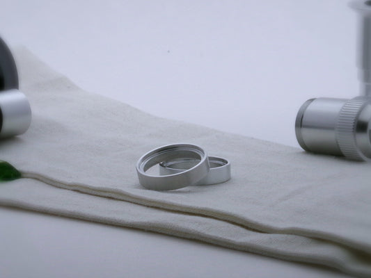 Pair of simple aluminum accent rings for VHC lightsabers, one askew upon the other, showing shimsert.