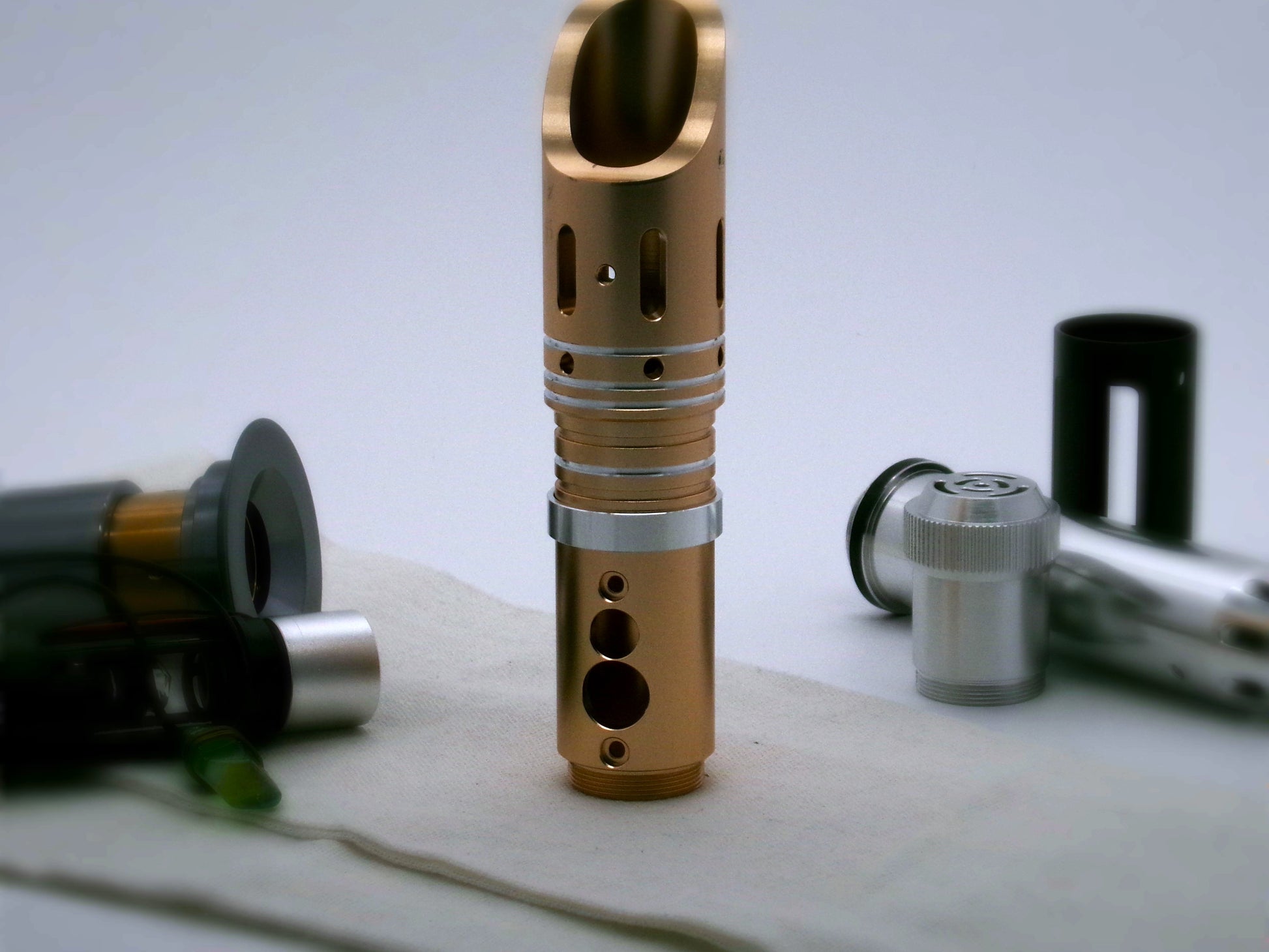 Single, aluminum accent ring installed on a golden lightsaber between the switch and emitter of a VHC lightsaber.