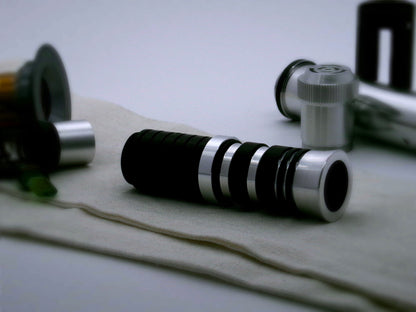 A single, simple aluminum accent ring installed between a mixed finish emitter and black extension of a VHC lightsaber.