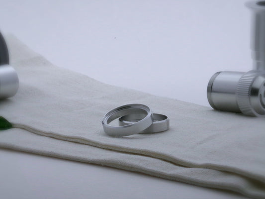 Pair of simple aluminum accent rings, with beveled edges for VHC lightsabers, one askew upon the other, showing shimsert.