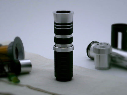 Single, aluminum accent ring with beveled edges installed between a mixed finish emitter and black extension of a VHC lightsaber.