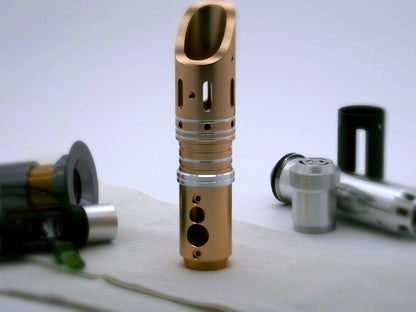 Single, aluminum accent ring with beveled edges and a central groove installed between the switch and emitter of a golden bodied VHC lightsaber.